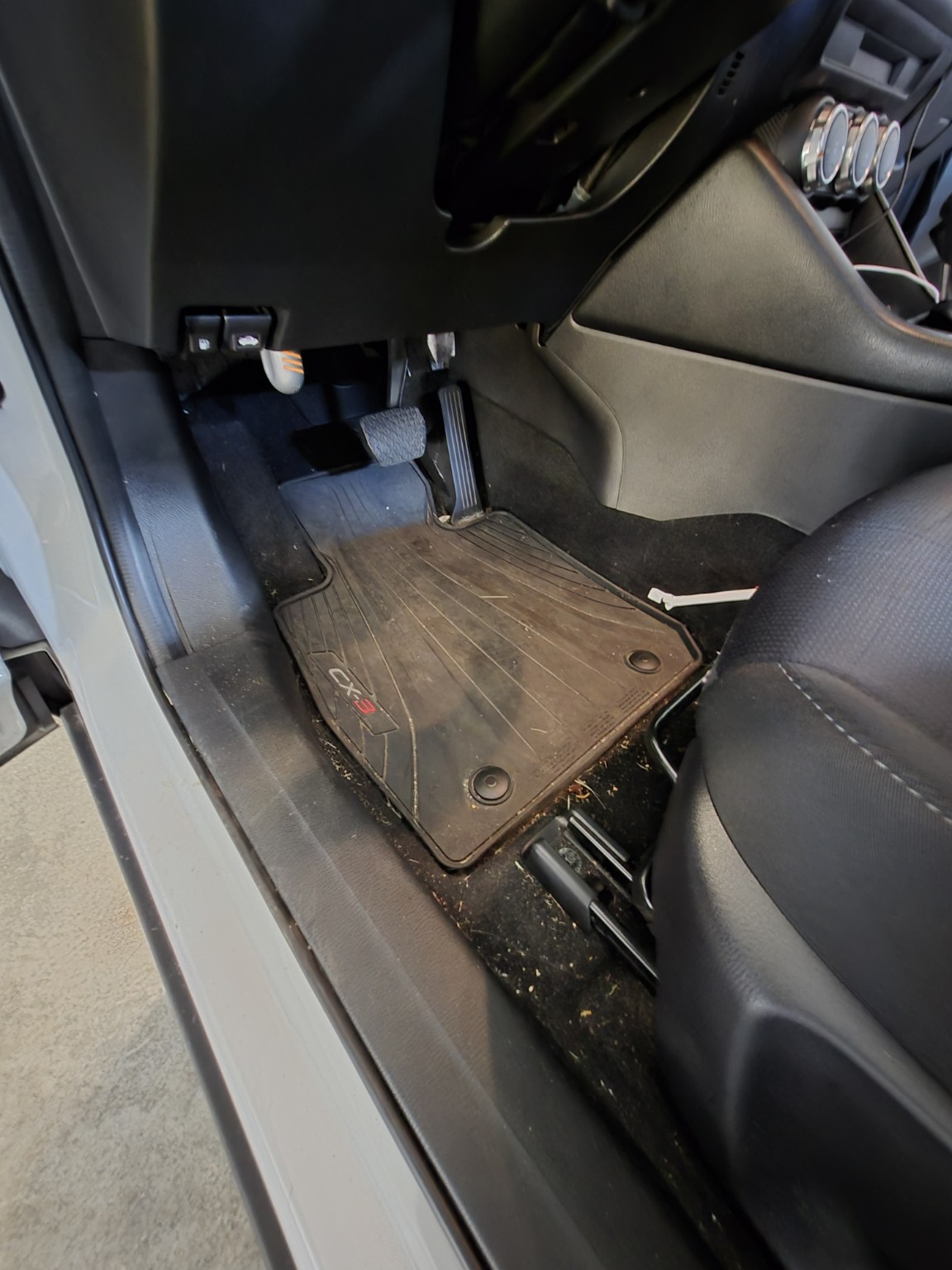 Car driver-side floor before interior detailing